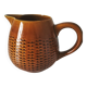 Caramel slipware pitcher with braided relief