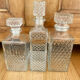 Set of 3 vintage whisky carafe bottles in molded glass