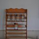 Brown wooden wall spice rack with a set of 6 glass jars, 1950s vintage style.