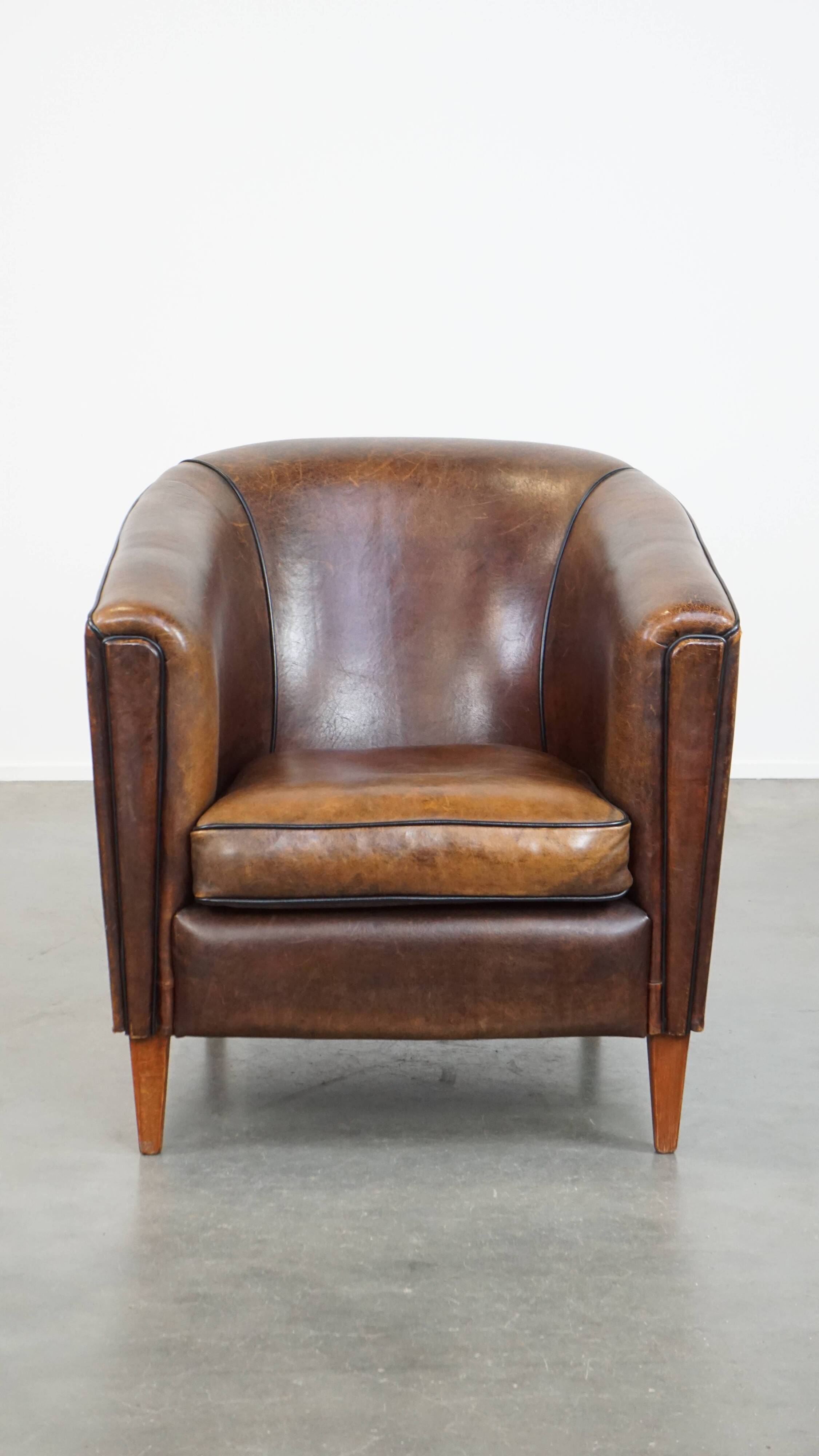 Sheep leather club chair finished with black piping