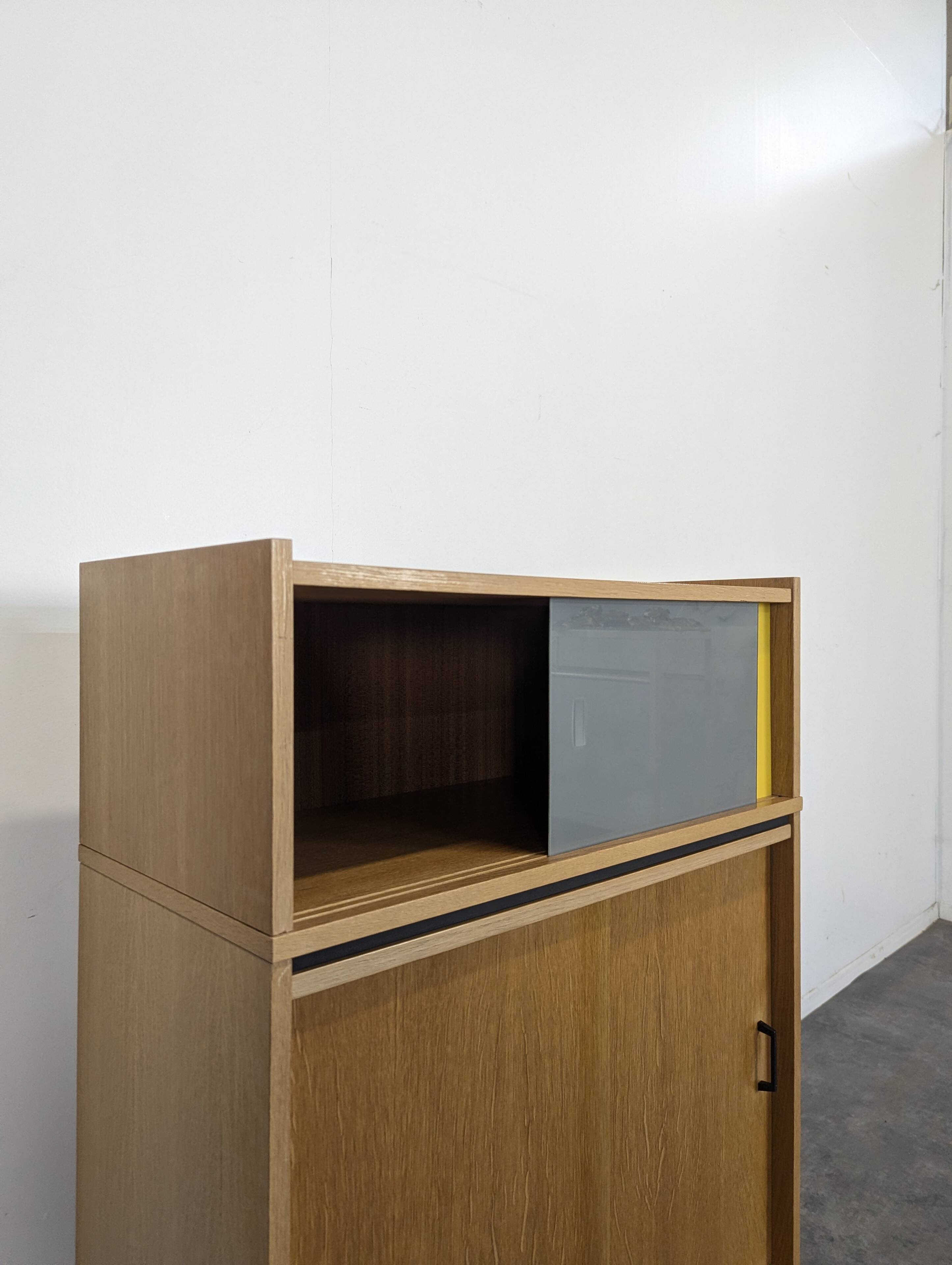 Modernist sideboard with glass doors in grey and yellow oak veneer.