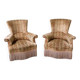 Pair of sculptural Hollywood Regency lounge chairs with original fringed upholstery