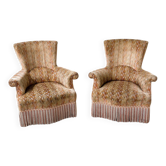 Pair of sculptural Hollywood Regency lounge chairs with original fringed upholstery