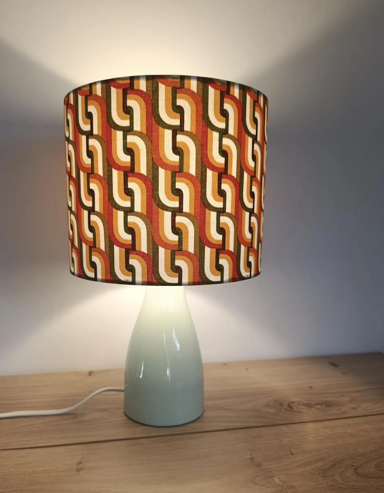 Seventies spirit lamp with geometric orange/green lampshade.
