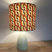 Seventies spirit lamp with geometric orange/green lampshade.