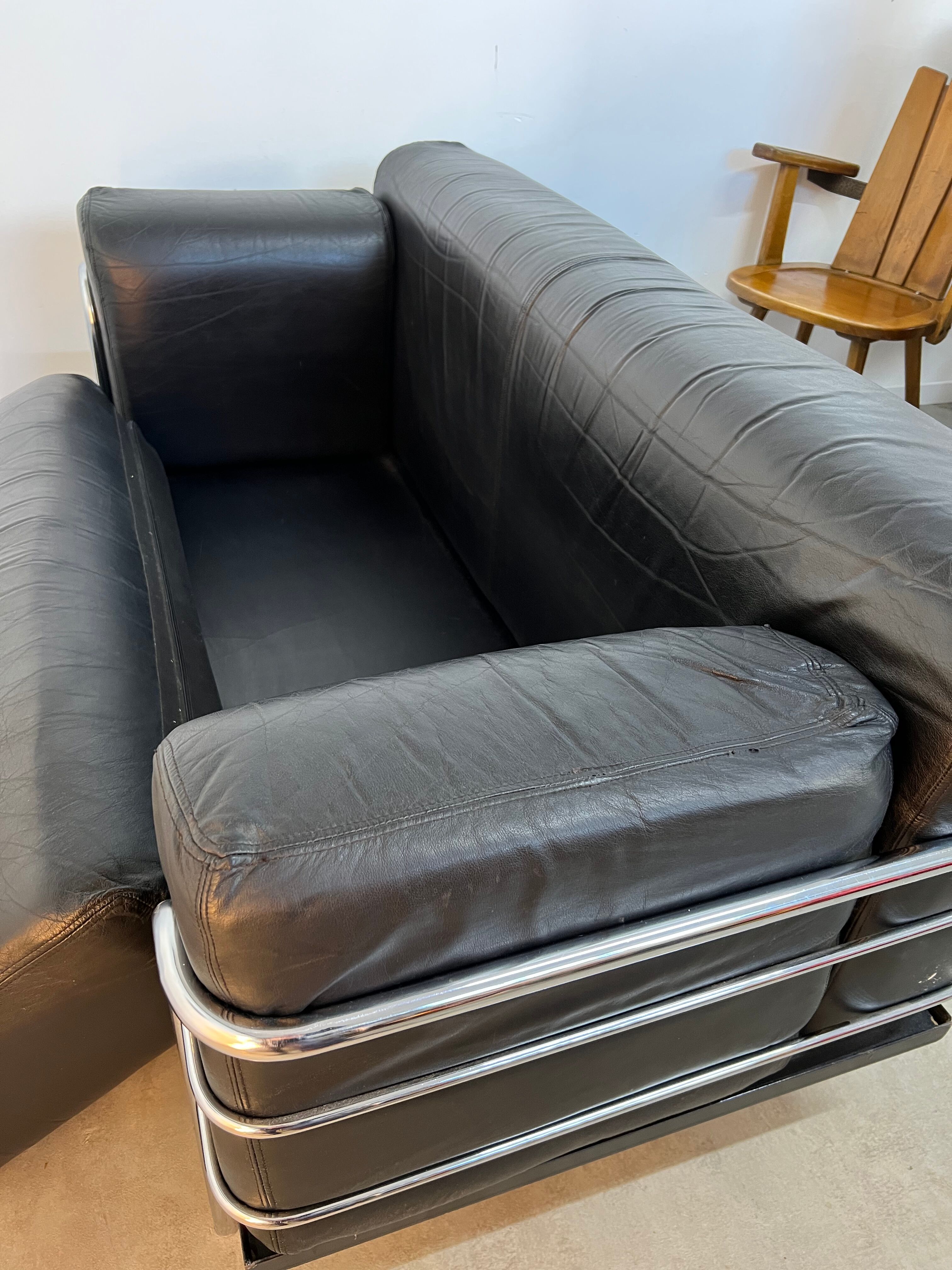 Old vintage leather and tubular metal sofa, design 70s