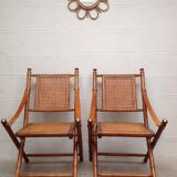 Pair of folding chairs in bamboo and caning, leather and brass