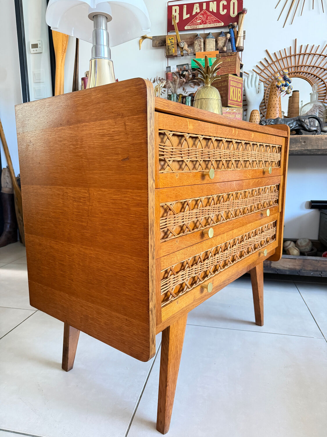 Vintage wooden and rattan chest of drawers with tapered legs.