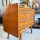 Vintage wooden and rattan chest of drawers with tapered legs.