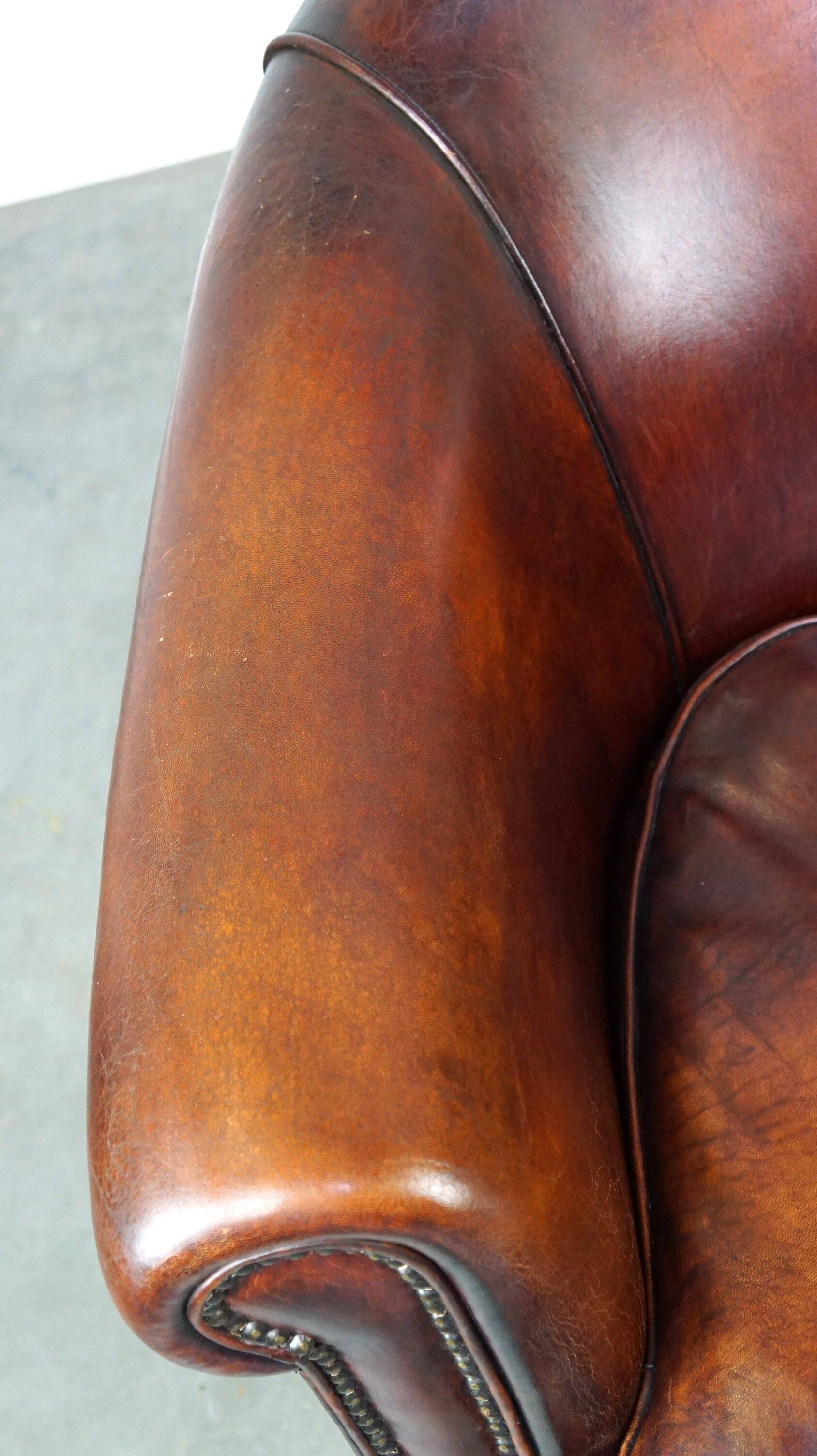 Very luxurious dark brown sheepskin club chair with a more than beautiful patina