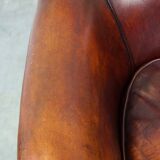 Very luxurious dark brown sheepskin club chair with a more than beautiful patina