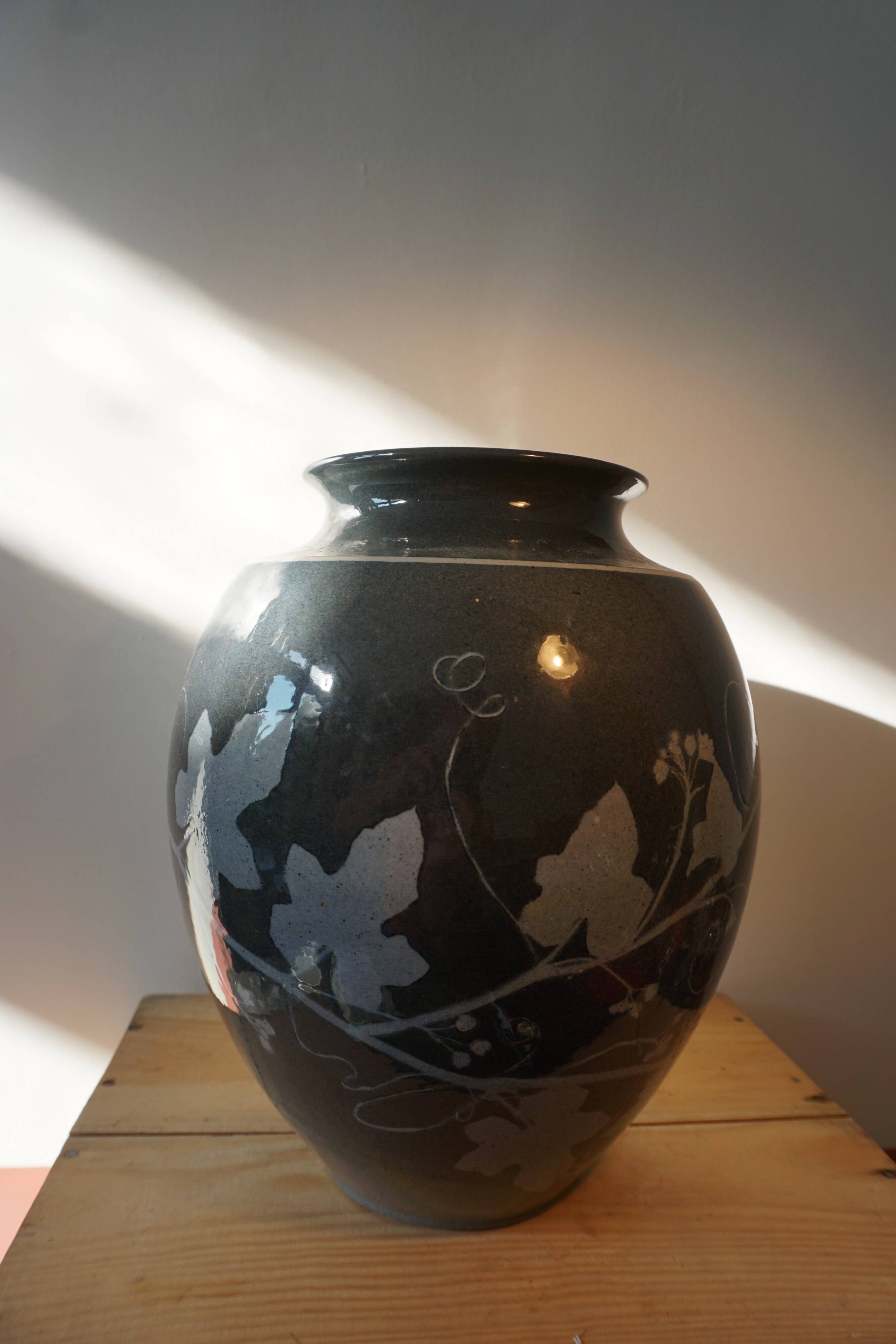 Black vase with plant decoration by Philippe Jacques