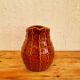 Vintage Saint Clément pitcher with a caramel checkered design.
