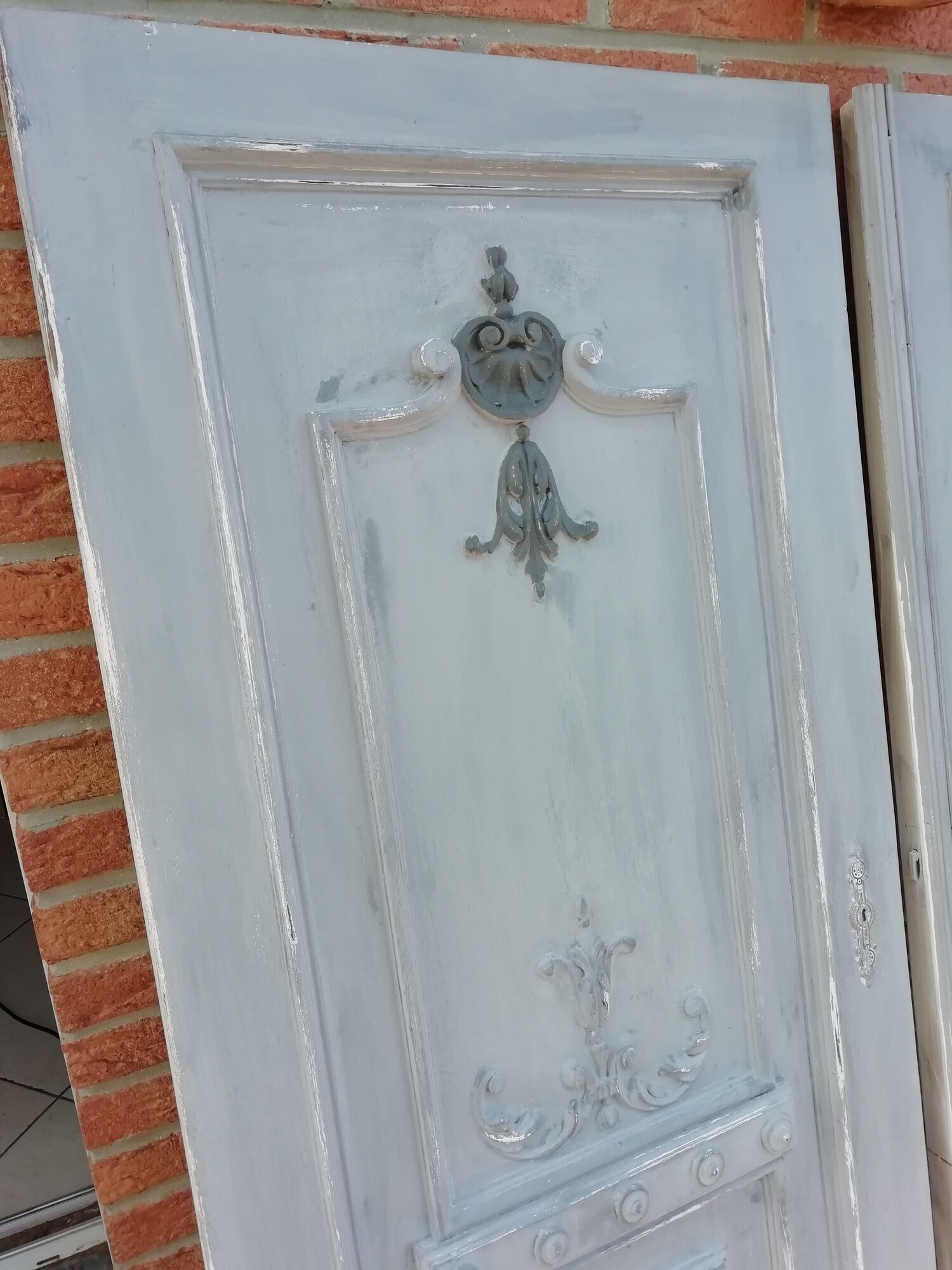 Pair of old door painted in carved wood