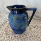 Antique pitcher in enamelled ceramic
