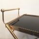 Golden brass trolley wheeled dessert and glass trays