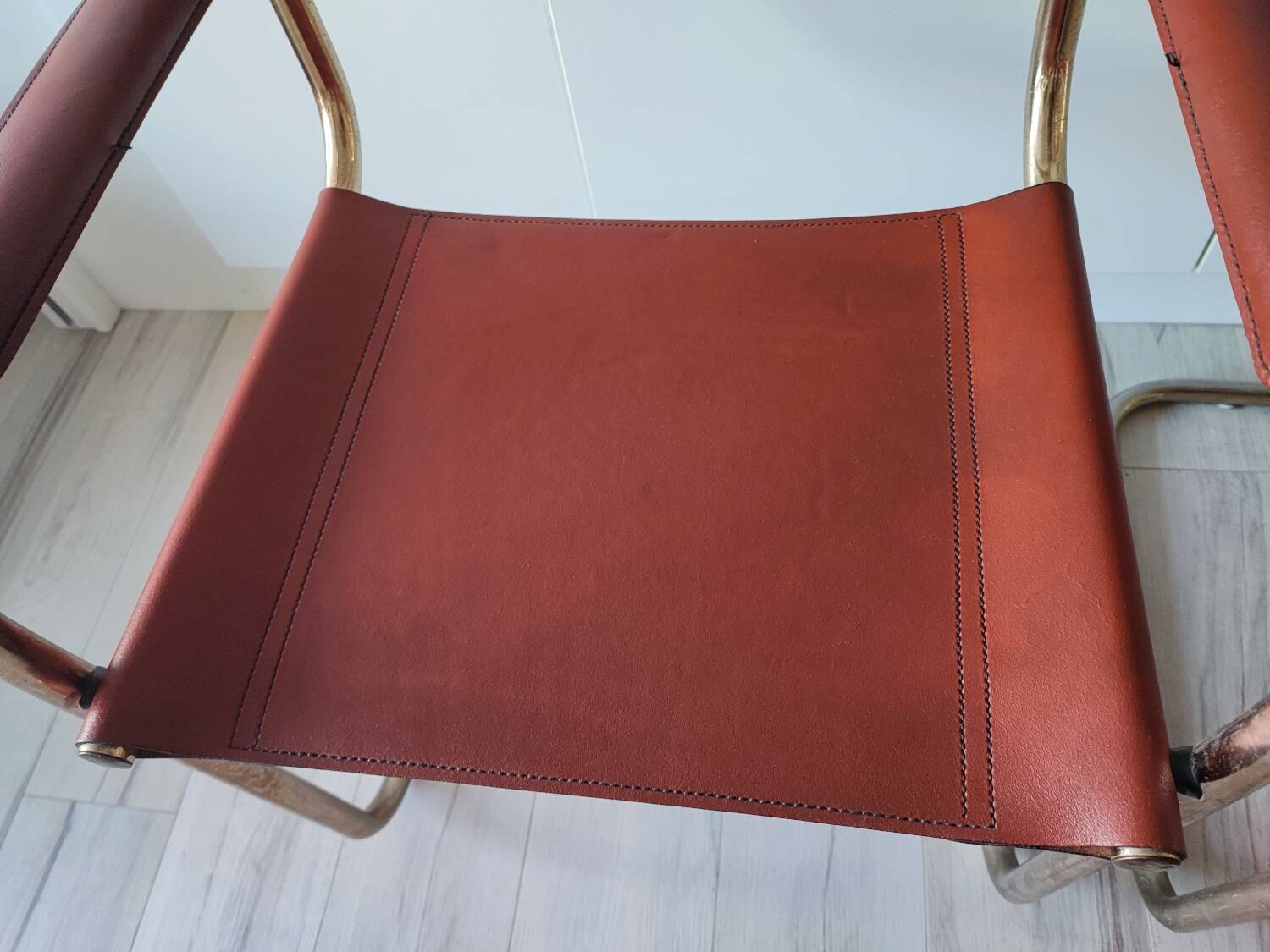 B34 armchairs, cognac leather and gilding