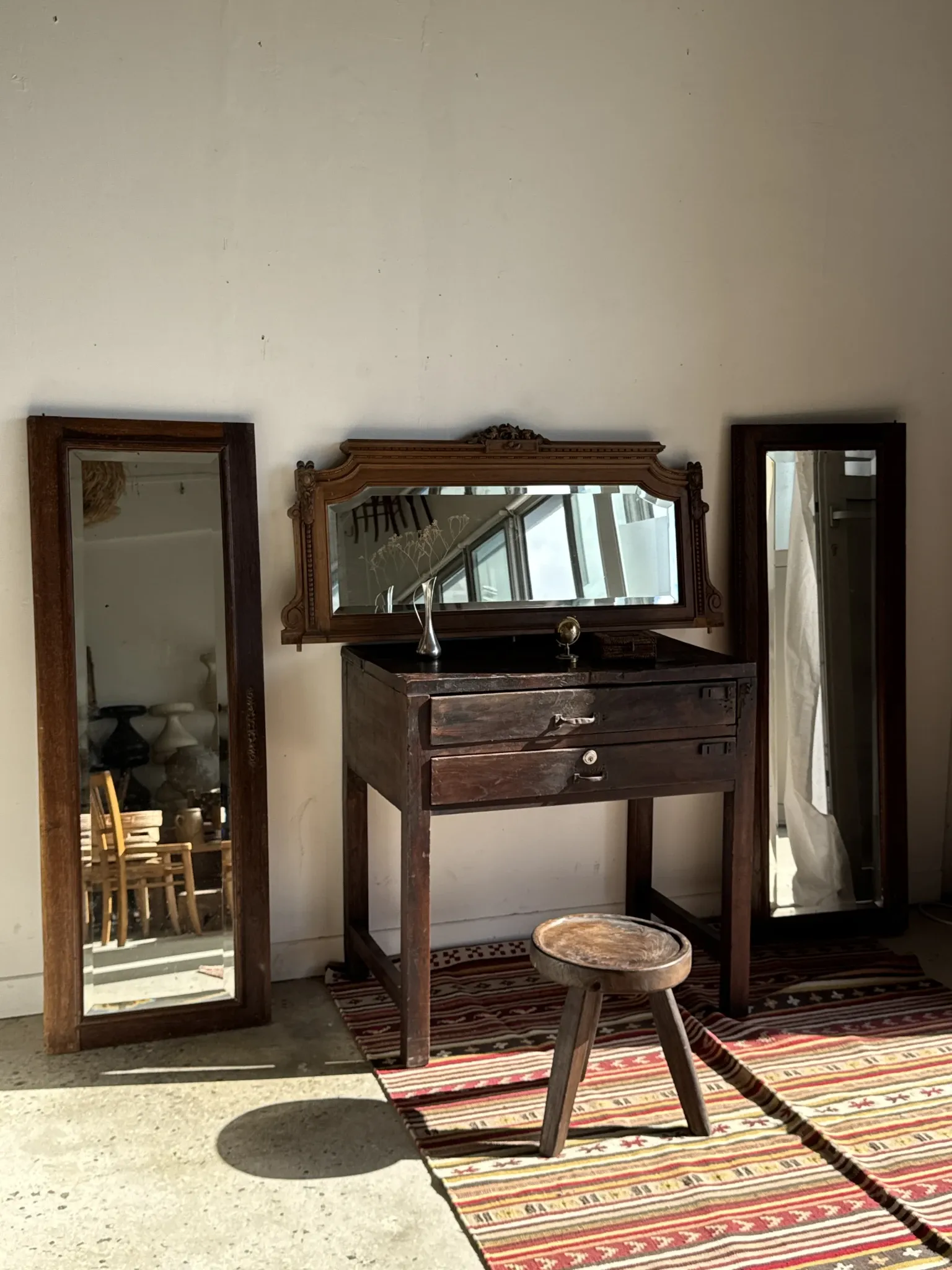 Antique mirror door (left) of a brown oak wardrobe with bevelled glass.