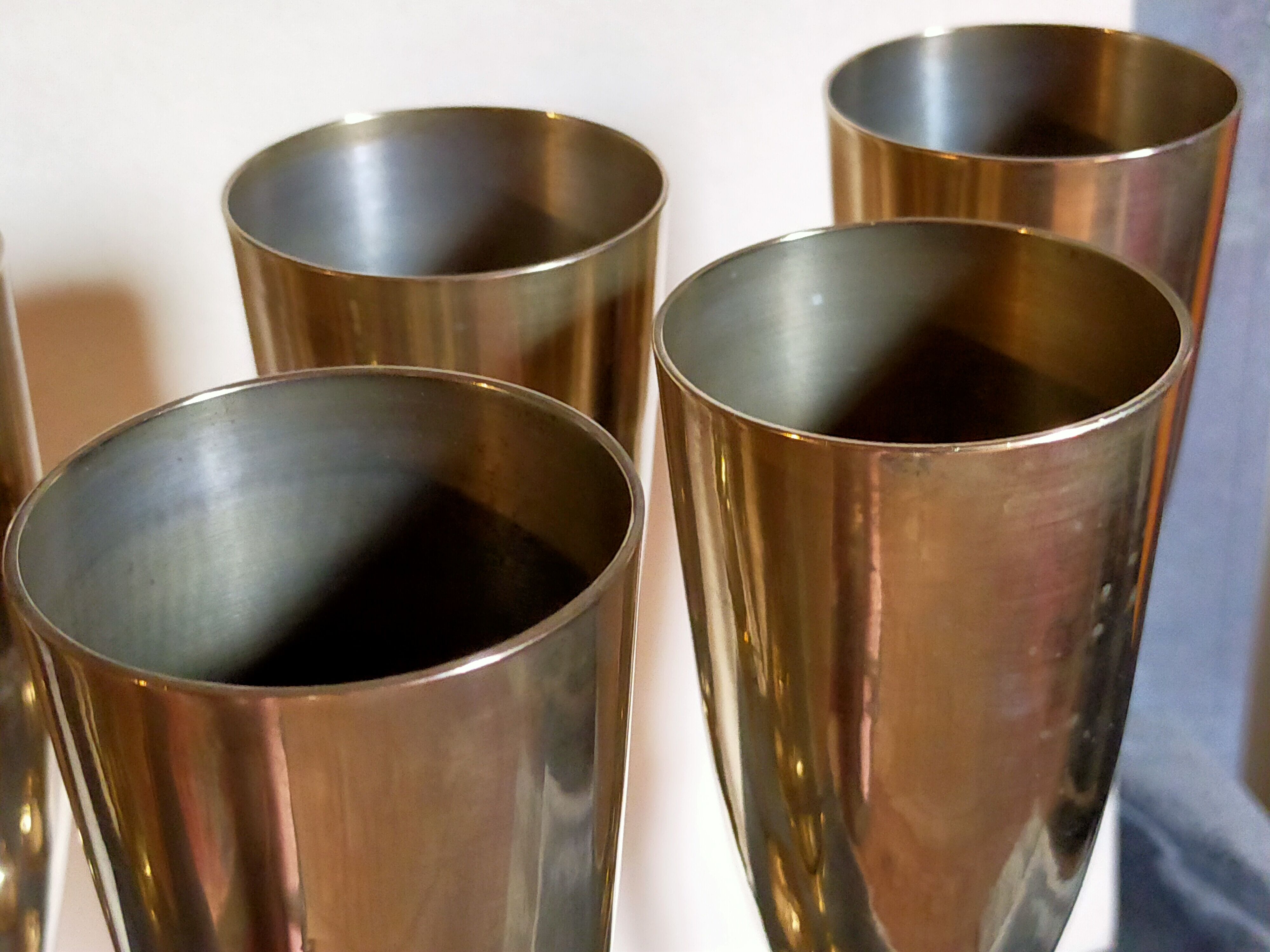 Six brass champagne coupes