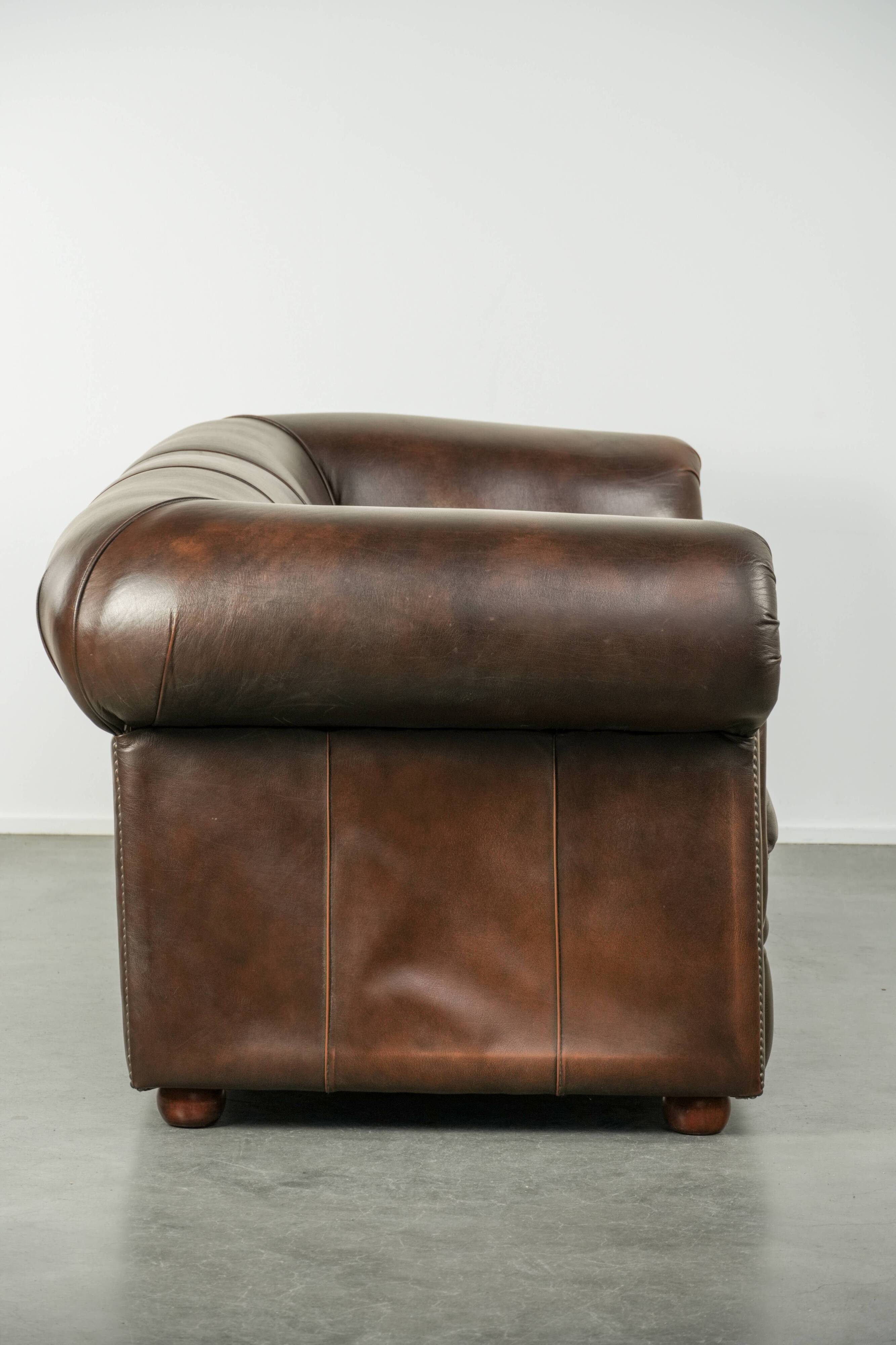 Set of a smooth chesterfield sofa and armchair with a timeless English look