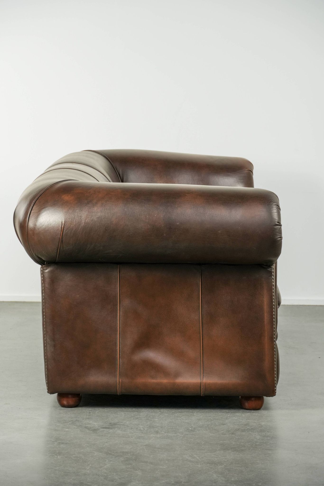 Set of a smooth chesterfield sofa and armchair with a timeless English look