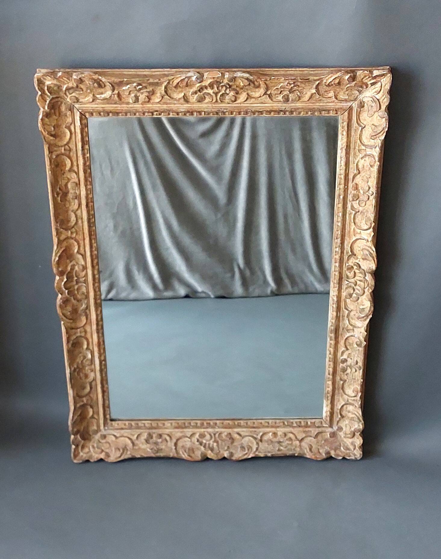 Large Montparnasse rocaille style frame in carved wood mounted in mirror.