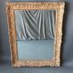 Large Montparnasse rocaille style frame in carved wood mounted in mirror.