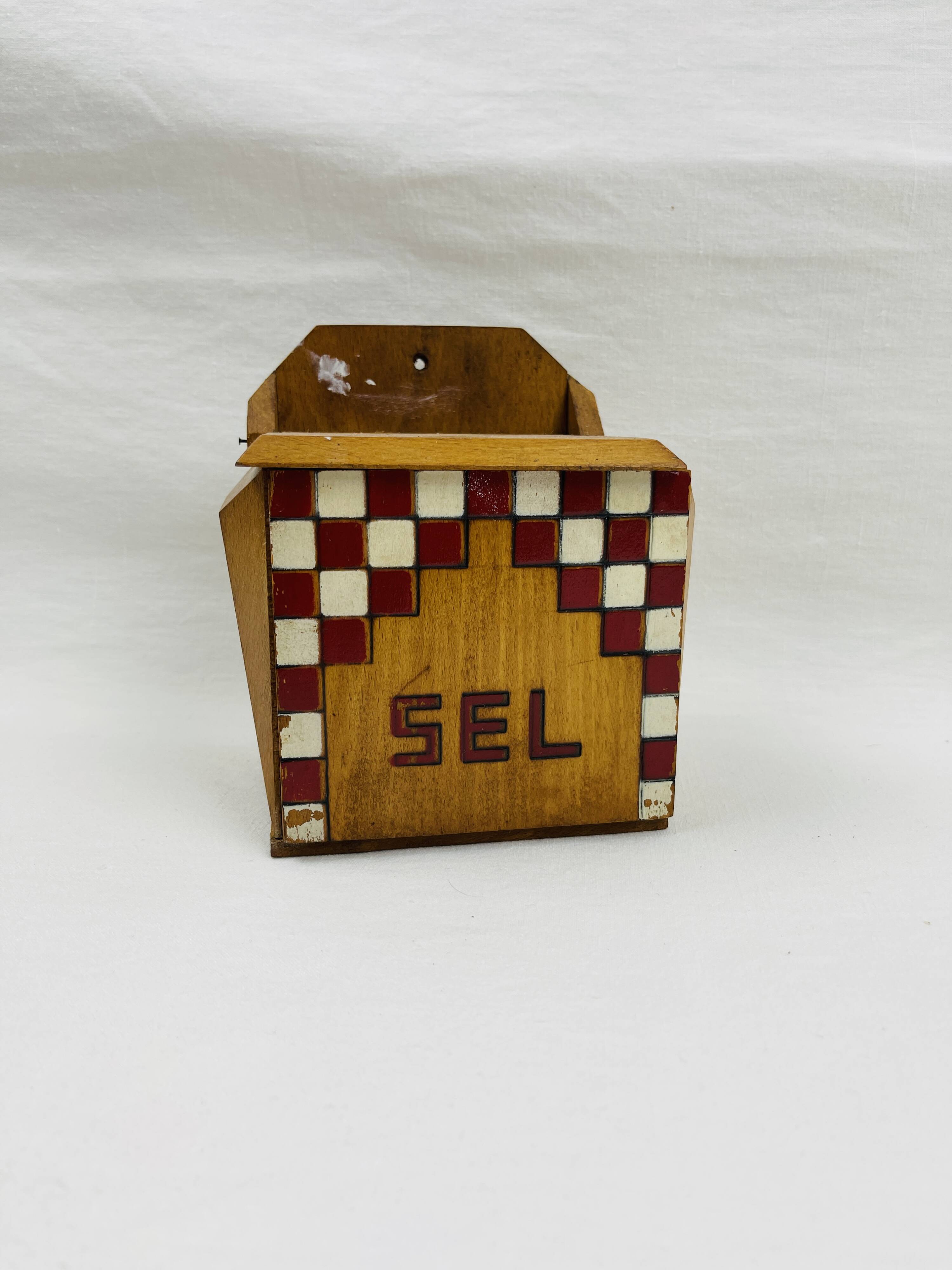 Old wooden salt box with red and white checkerboard decoration