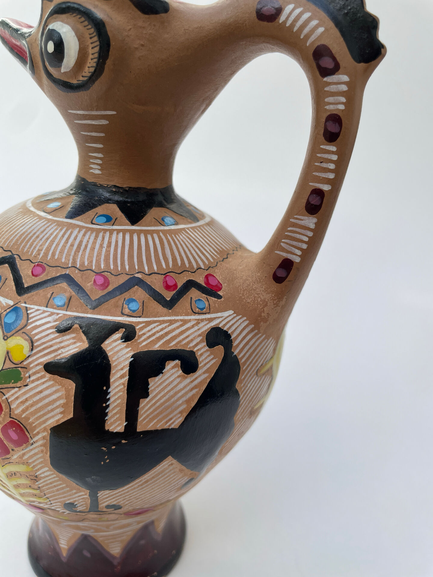 Clay pitcher with a bird head