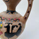 Clay pitcher with a bird head