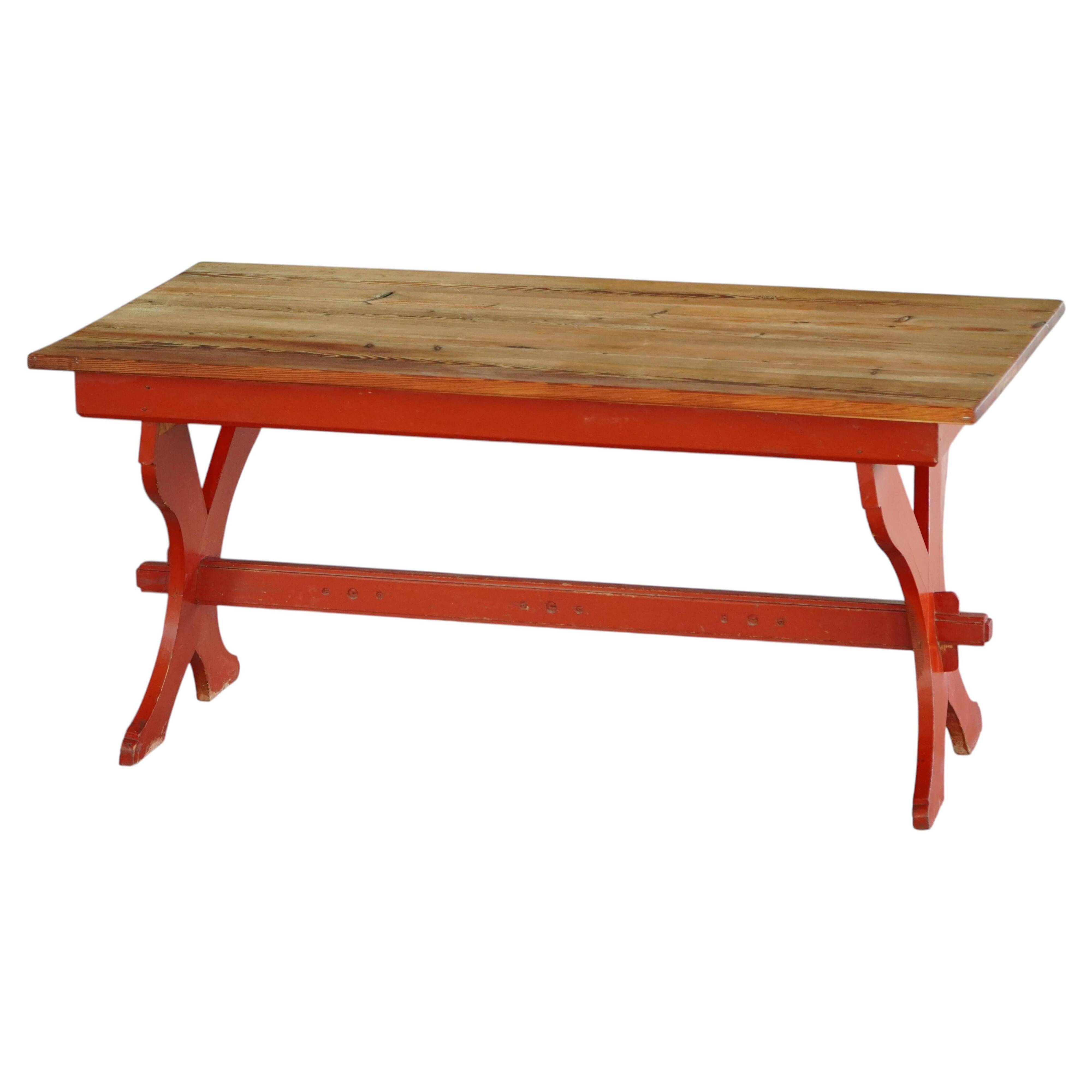 Rustic farmhouse dining table in painted red pine, Sweden, 1920s.