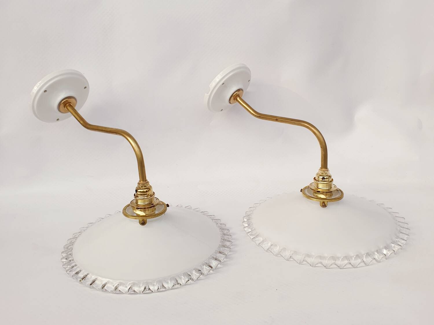 Swan neck sconces in serrated opaline