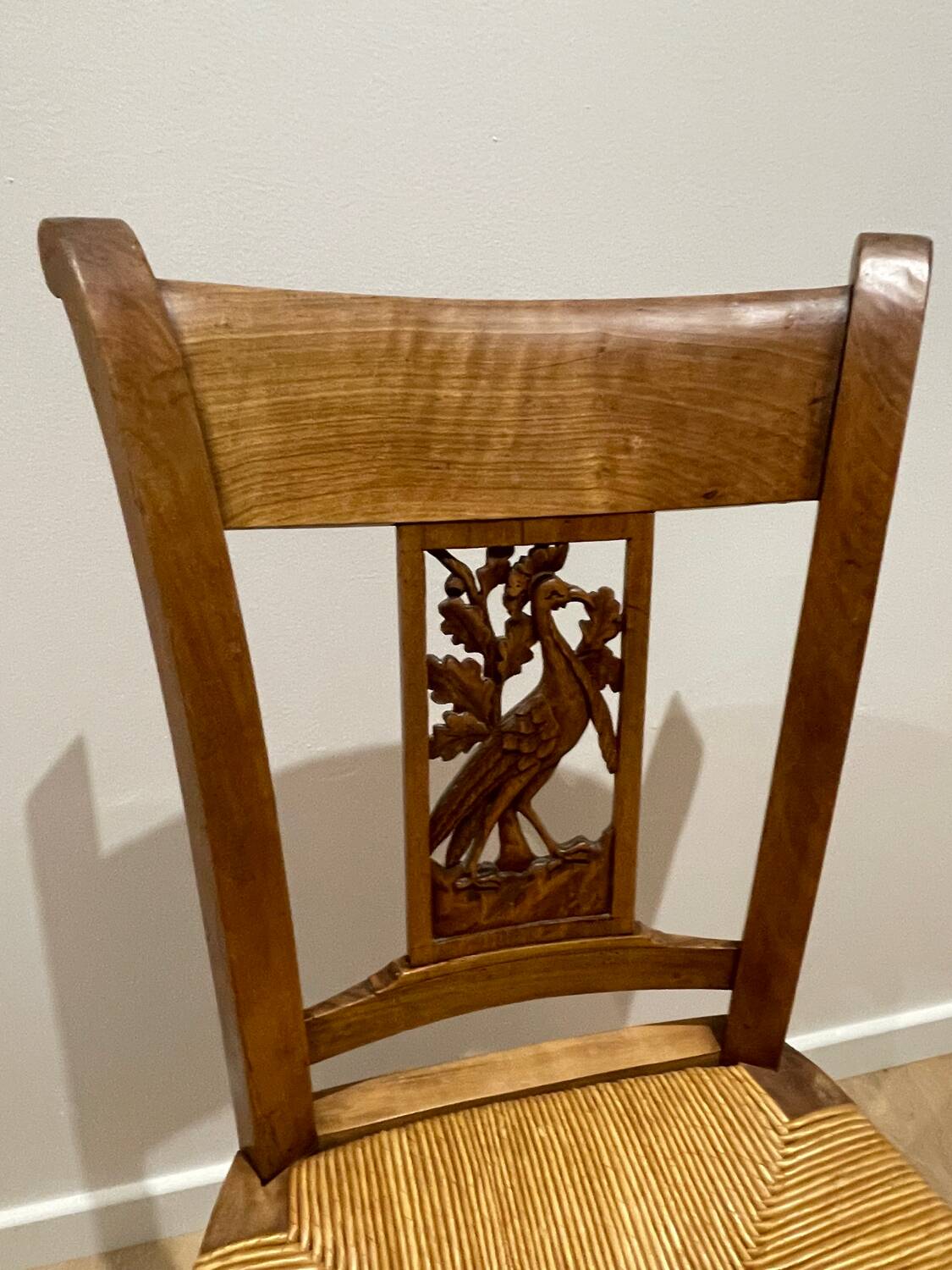 19th century straw chair with carved peacock back
