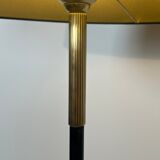 Designer floor lamp in black lacquered metal and brass, incorporating a magazine rack
