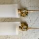 Pair of gold steel wall lamps, plexi and pleated plastic shades 60s-70s