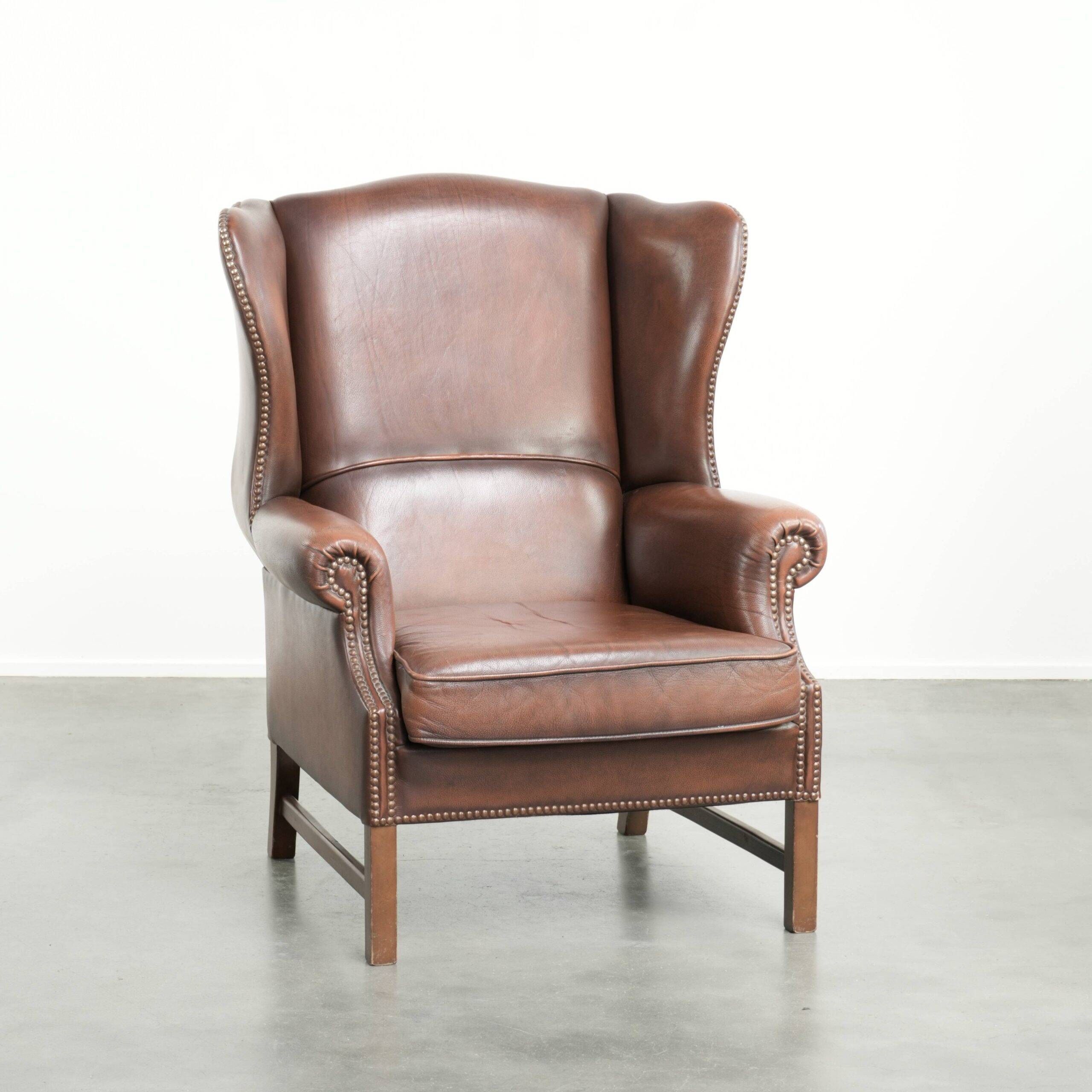 Comfortable cowhide wingback armchair in English style with a timeless look
