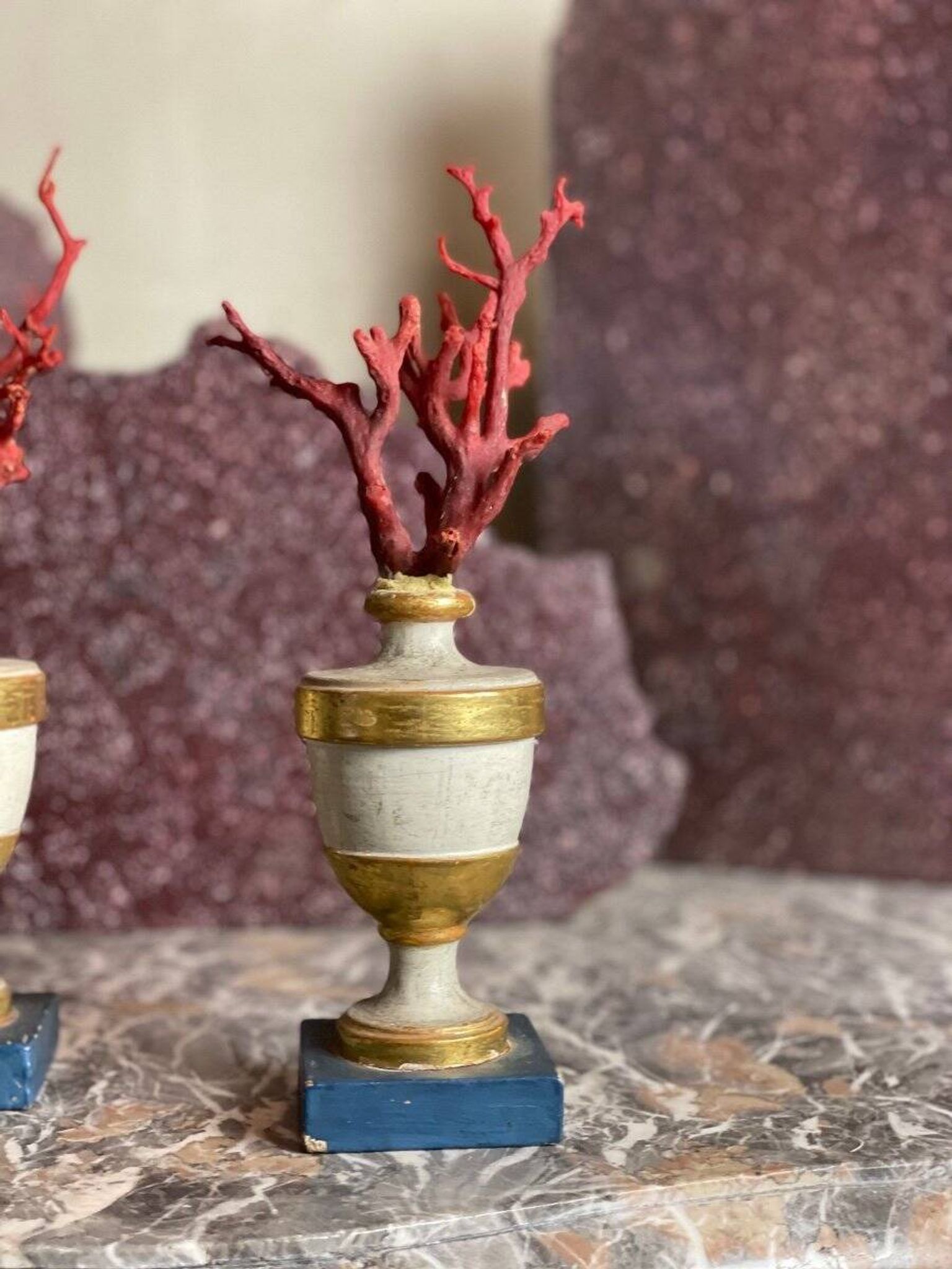 Pair of red corals on gilded and blue wooden bases