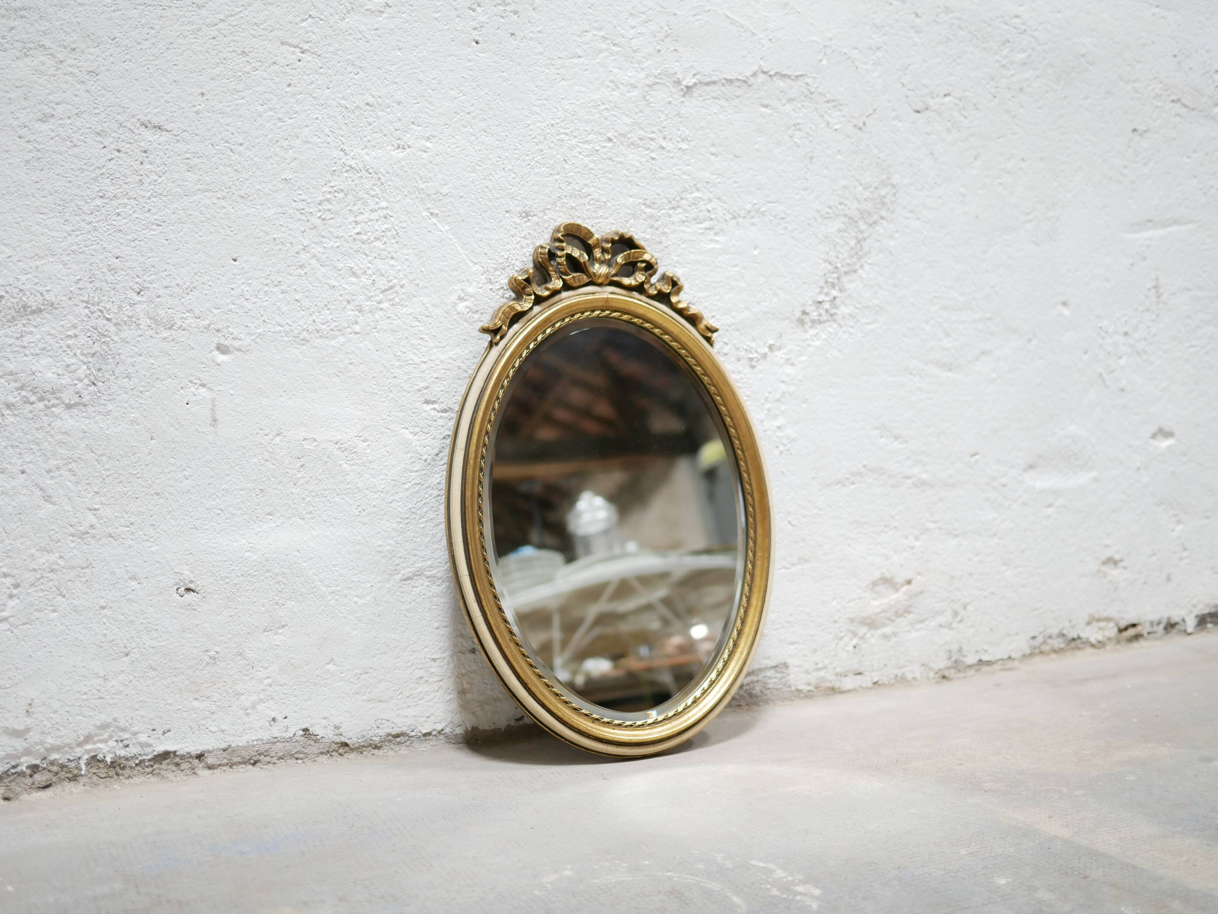 Old oval mirror Louis XVI style in gilded wood 50cm x 34cm