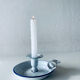 Old candle holder in white enameled metal