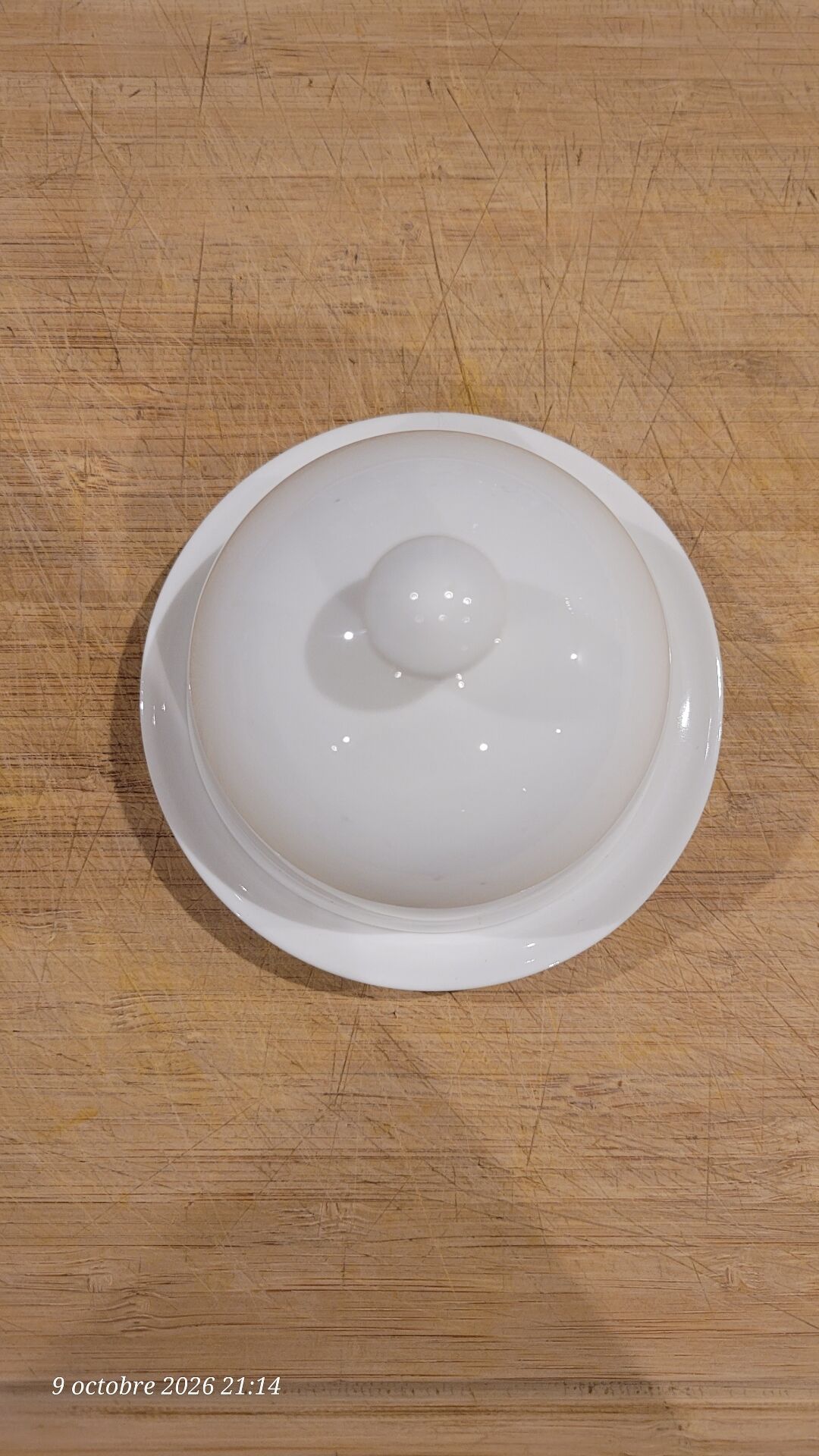 White porcelain butter dish accompanied by its matching bell.