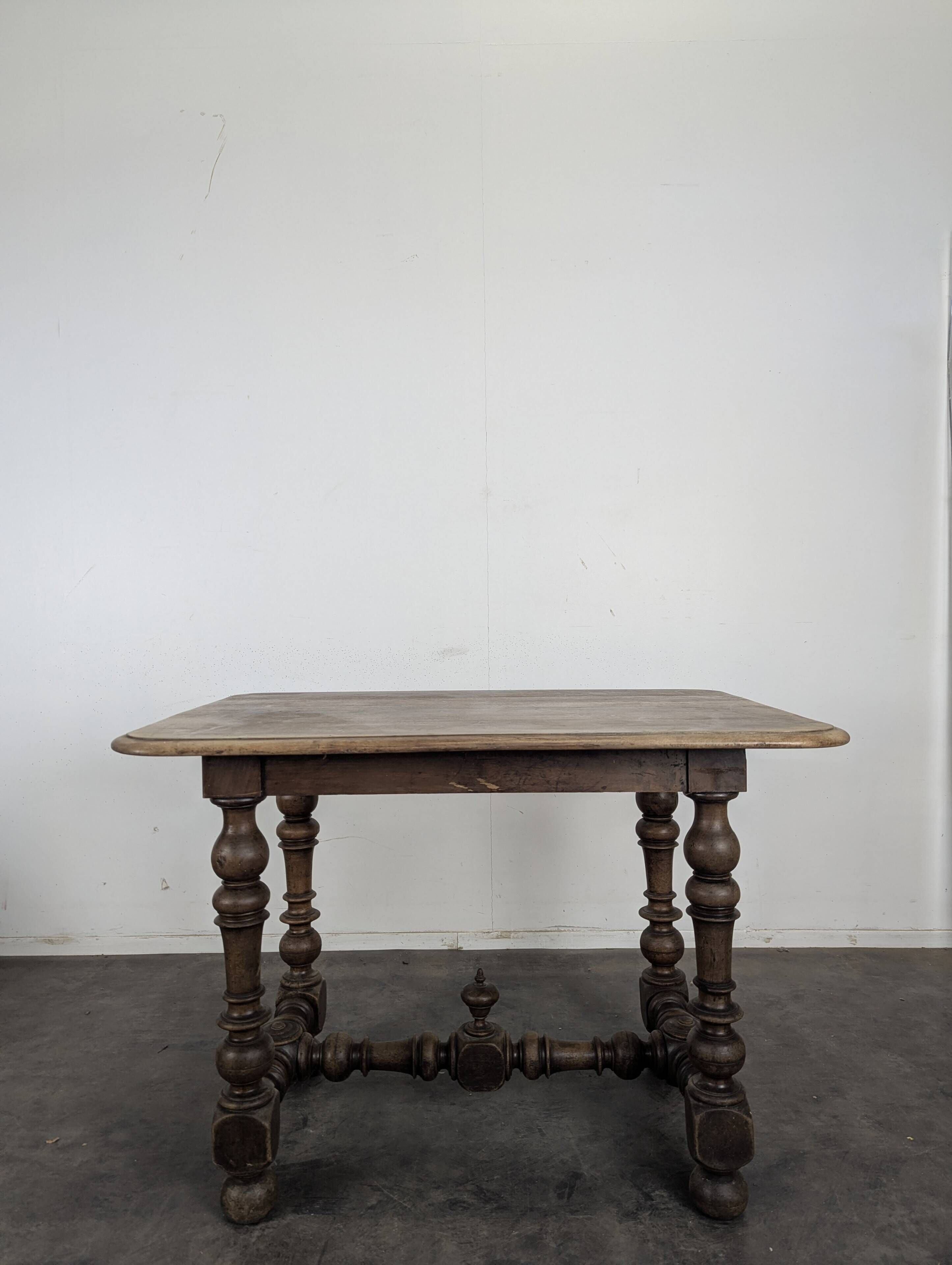 Louis XIII oak table with baluster legs and H stretcher.