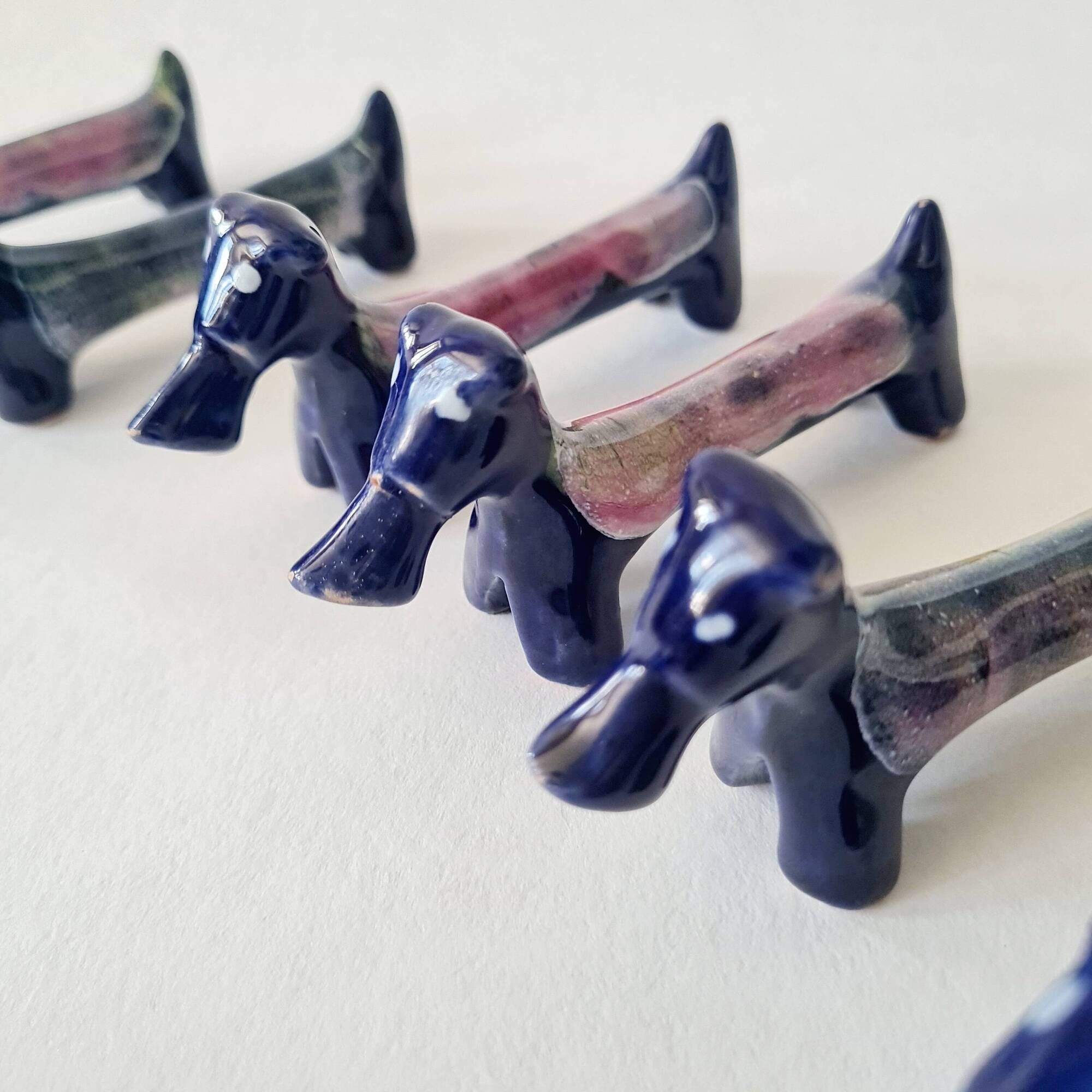 Set of 8 vintage ceramic knife rests, retro dog design.