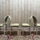 Suite de 4 chaises médaillons de style Louis XVI rechampi blanc cassé