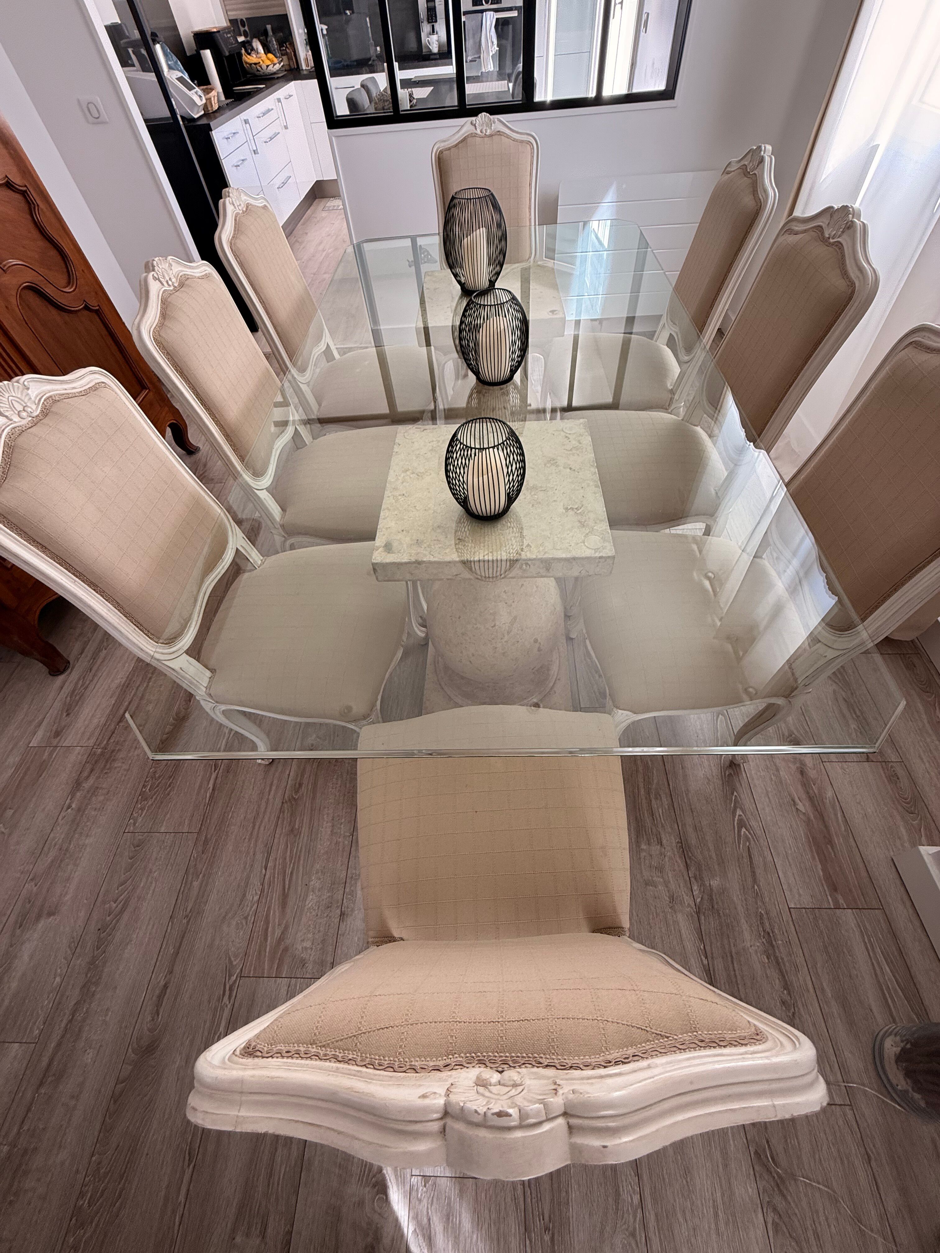 Table with a glass top and 8 chairs.