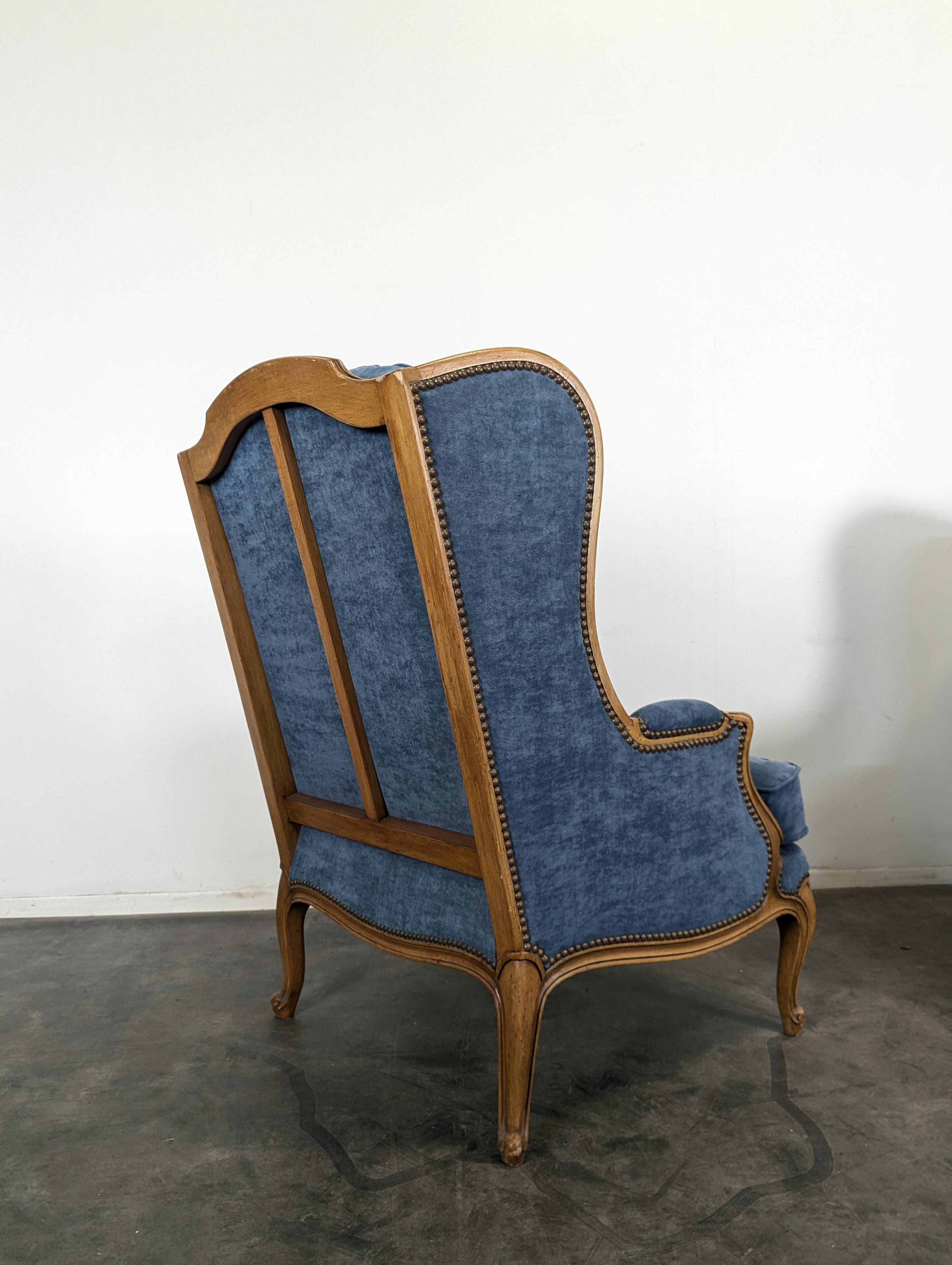Pair of Louis XV style wingback armchairs in blue velvet.