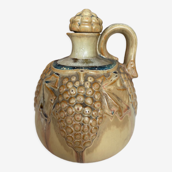 Wine pitcher in stoneware motifs grapes in relief signed Denbac