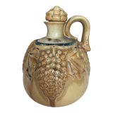 Wine pitcher in stoneware motifs grapes in relief signed Denbac