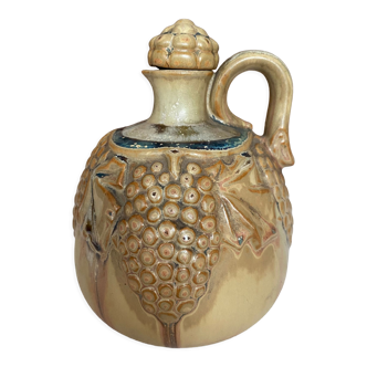 Wine pitcher in stoneware motifs grapes in relief signed Denbac