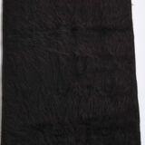 Small vintage flat-woven black rug.