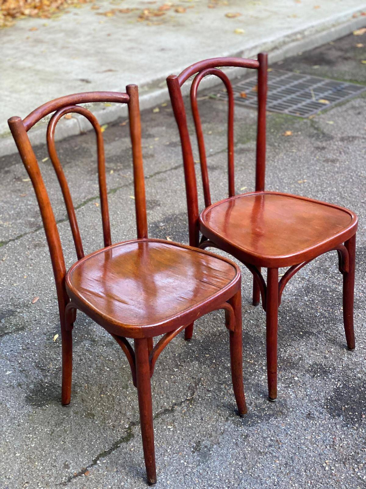 2 curved solid wood bistro chairs in Bordeaux.